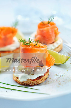 Blinis topped with smoked salmon, cream and gherkins Blinis topped with smoked salmon, cream and gherkins