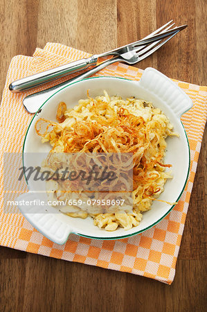 Cheese Spätzle (soft egg noodles from Swabia) in an enamel baking dish