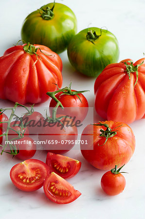 Various types of tomatoes with drops of water Various types of tomatoes with drops of water