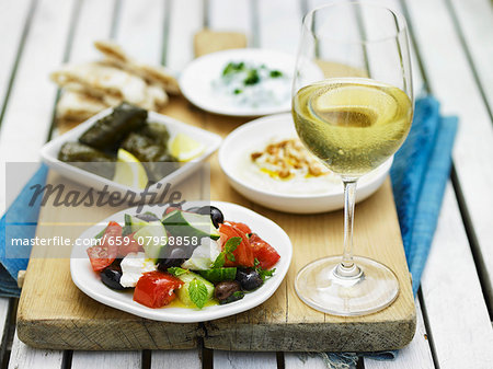 Greek food, white wine and unleavened bread Greek food, white wine and unleavened bread