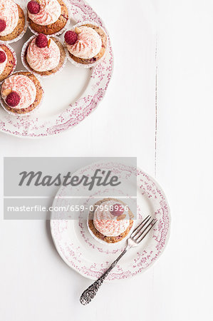 Raspberry and almond muffins decorated with buttercream and dried raspberry powder