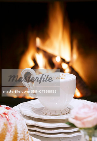 A cappuccino in front of an open fire A cappuccino in front of an open fire