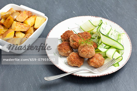 Meatballs served with a courgette salad and roast potatoes