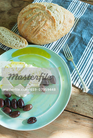 Sheep's cheese and black olives with olive oil and country bread Sheep's cheese and black olives with olive oil and country bread