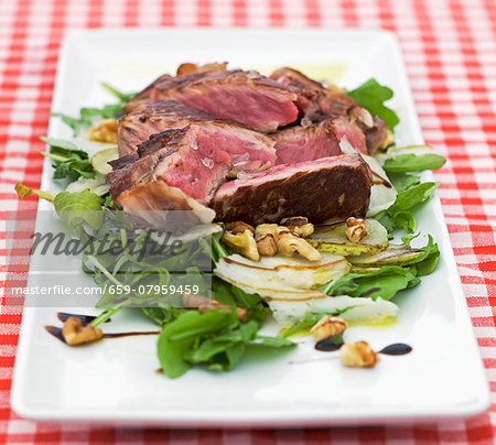 Grilled beef steak on a bed of lettuce