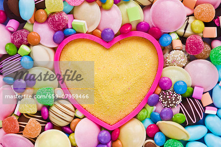 Yellow sugar in a baking mould surrounded by sweets Yellow sugar in a baking mould surrounded by sweets