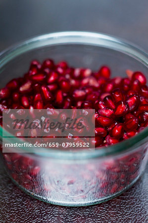 Pomegranate seeds in a glass jar