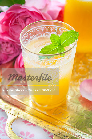 A peach cocktail with vodka and mint