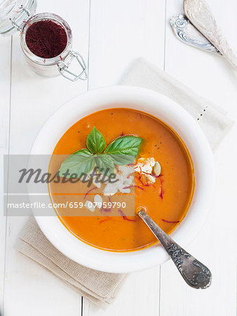 Tomato and pumpkin soup with saffron in a white bowl Tomato and pumpkin soup with saffron in a white bowl
