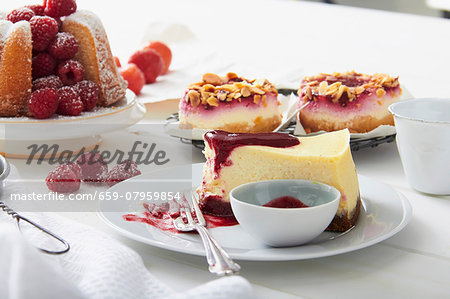 Vanilla cake, cheesecake and berry tartlets with almonds on a cake buffet