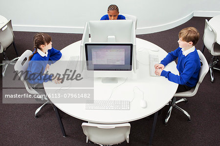 Primary school children working with computers during IT lesson