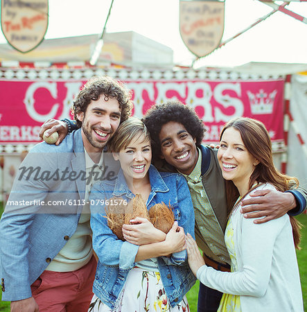 Portrait of four friends having fun in amusement park