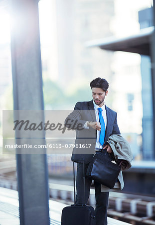 Businessman checking his watch in train station