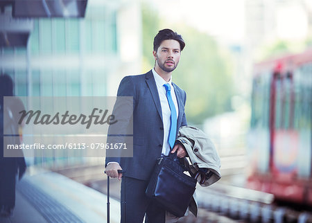 Businessman waiting at train station Businessman waiting at train station