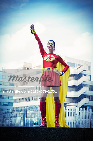 Superhero standing proudly in city