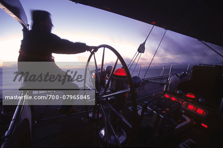 Captain helms Endeavour at Dawn towards Antigua with Navigational Instruments Glowing Red Captain helms Endeavour at Dawn towards Antigua with Navigational Instruments Glowing Red