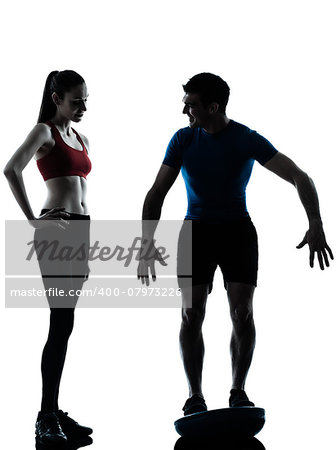 personal trainer man coach and woman exercising squats on bosu silhouette studio isolated on white background