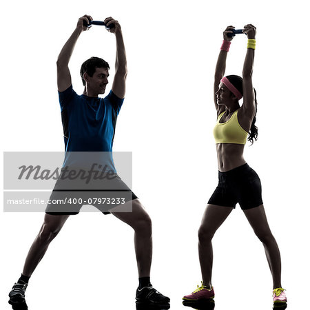 one woman exercising fitness weight training with man coach in silhouette on white background