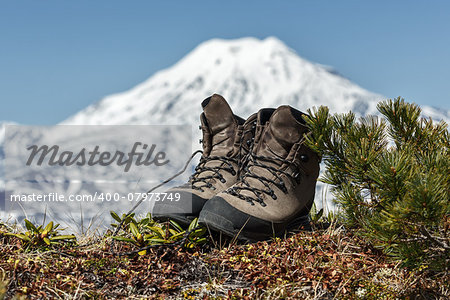 Tourist boots and volcano on Kamchatka Peninsula (Russia).