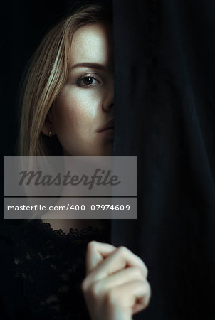 Portrait of a young girl with clean skin on a black background close-up