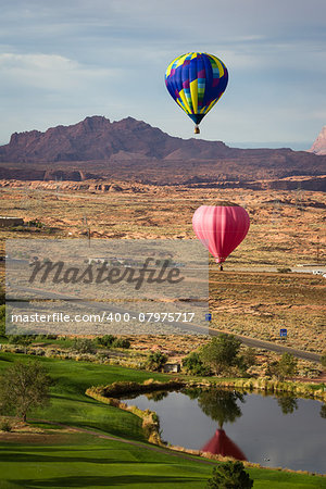 hot air balloon floating over the red navajo sandstone in Arizona with a beautiful landscape