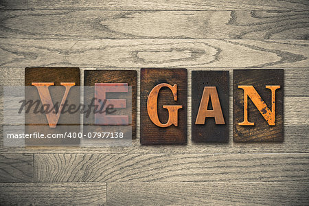 The word "VEGAN" written in wooden letterpress type.