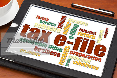 tax electronic filing concept - a word cloud on a digital tablet with a cup of tea