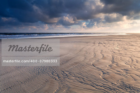 sunrise over North sea sand beach, Holland