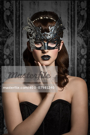 Mysterious, carnival, elegant, gorgeous female in silver mask with black lips and old fashioned hairstyle.