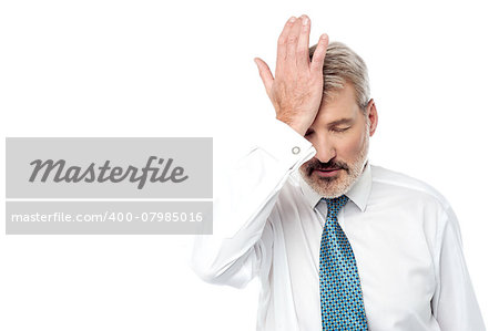 Businessman holding his hand near forehead