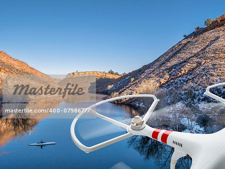 quadcopter drone flying over lake with a canoe - Horsetooth Reservoir near Fort Collins, Colorado