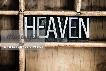 The word "HEAVEN" written in vintage metal letterpress type in a wooden drawer with dividers.