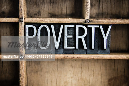 The word "POVERTY" written in vintage metal letterpress type in a wooden drawer with dividers.