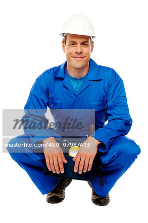 Smiling male worker wearing safety hat and relaxing, break from work