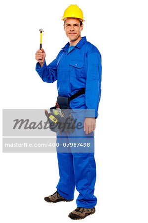Happy young construction worker holding hammer and carrying tools bag