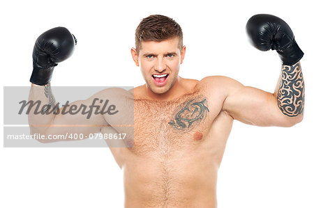 Attractive young boxer posing strongly with raised arms. Won fight