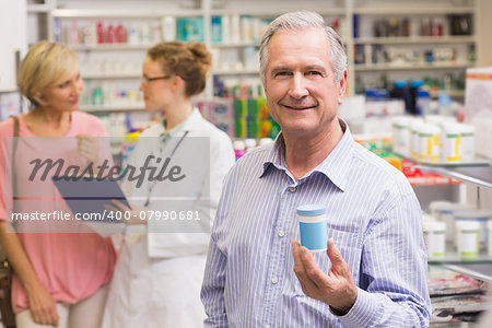 Costumer showing medicine jar at pharmacy