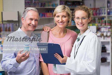 Pharmacist smiling at camera at pharmacy