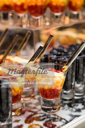 Close-up of Glasses of Fruit Cocktail and Shot Glasses of Blueberries on Dessert Table