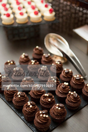 Chocolate Cupcakes topped with Coffee Beans on Dessert Table at Wedding Reception