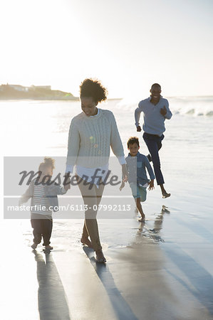 Happy walking on beach at sunset