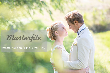 Portrait of young couple embracing in domestic garden