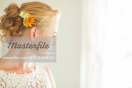 Portrait of bride looking out of window