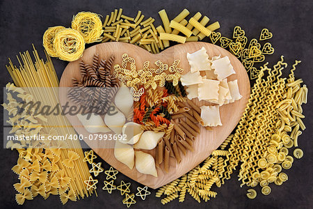Pasta food selection on a heart shaped wooden board.