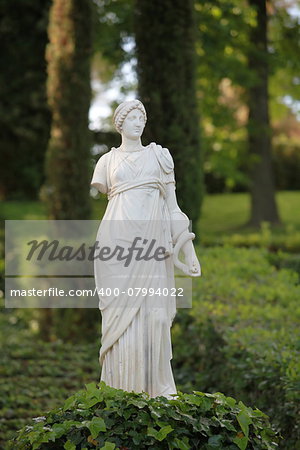 Antique  marble sculpture Women  among the greenery of the park