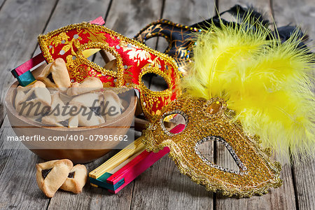 Hamantaschen cookies or Haman's ears, noisemaker and carnival masks for Purim celebration (jewish holiday).