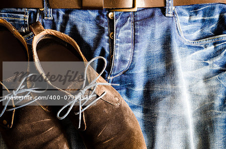 Detail of vintage style shoes on denim jeans