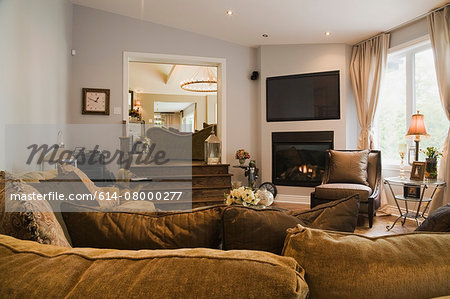 Living room with fireplace and L-shaped sofa in luxury home