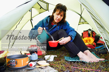 Woman preparing food in tent