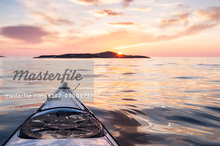 Kayak on water at sunset